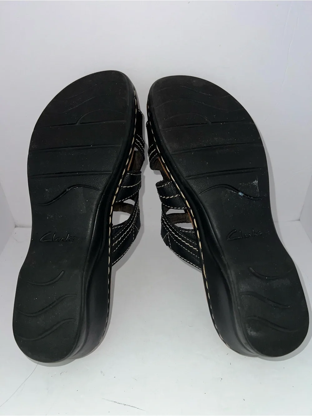 Clarks Women’s Black Leather Slip-On Sandals with Flower Accent